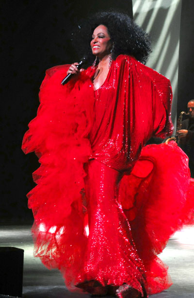 Diana Ross red boa hand on hip smiline